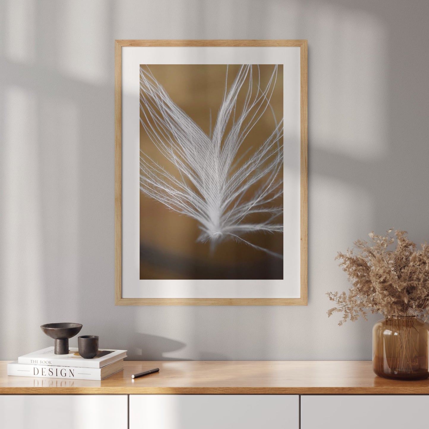 Poster with a photo of a feather on a gold background