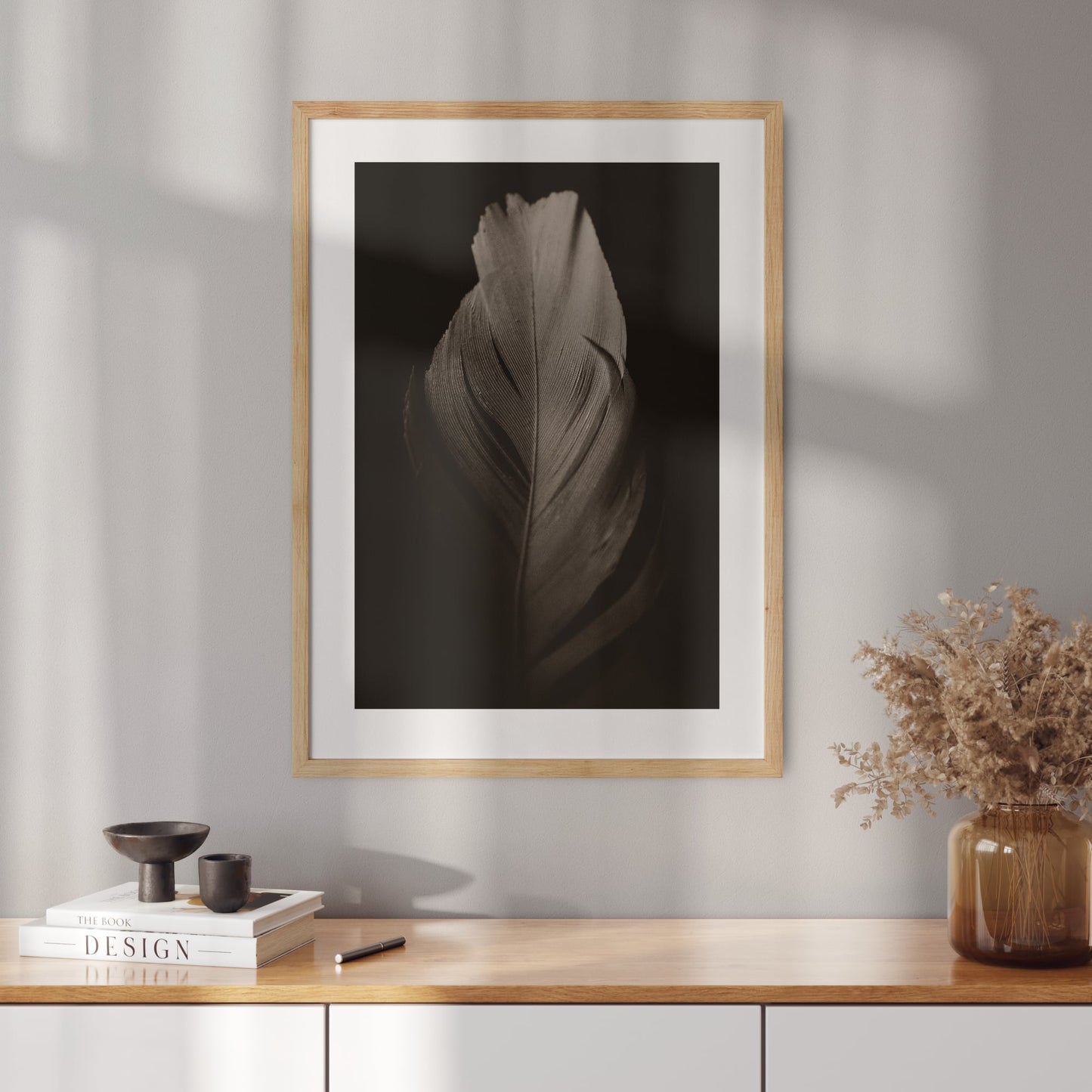 Poster with a photo of a feather on a black background
