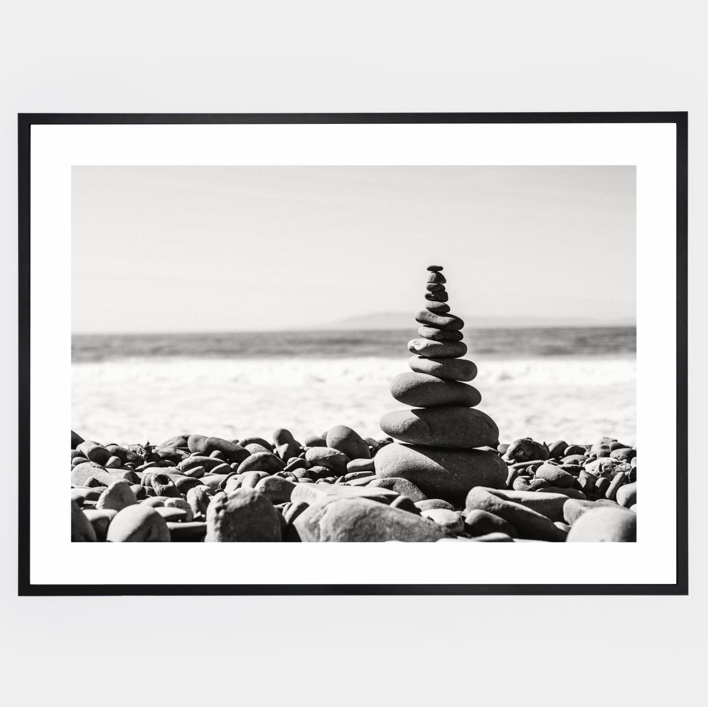 Poster with a photo of a tower made of pebbles