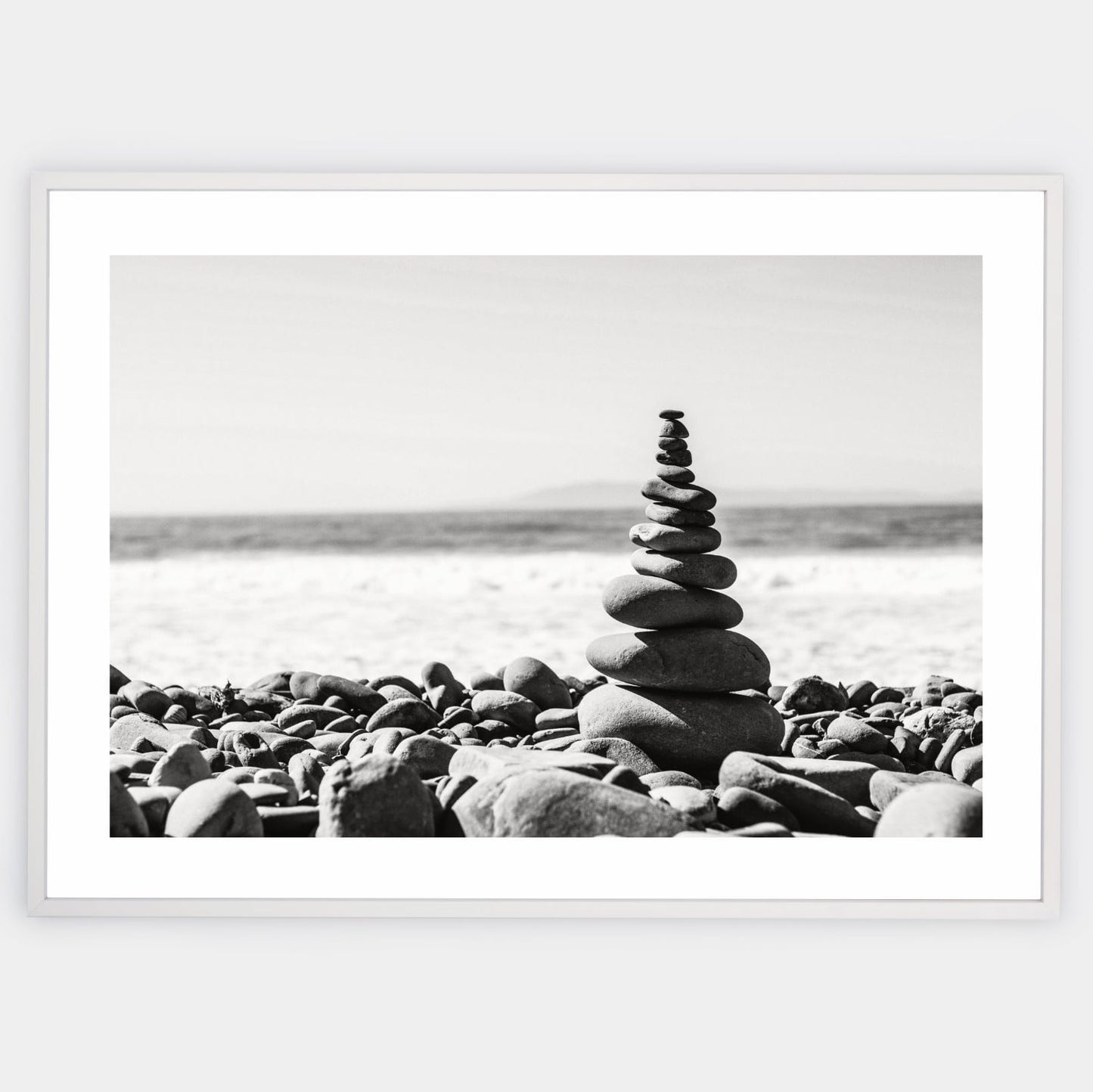 Poster with a photo of a tower made of pebbles