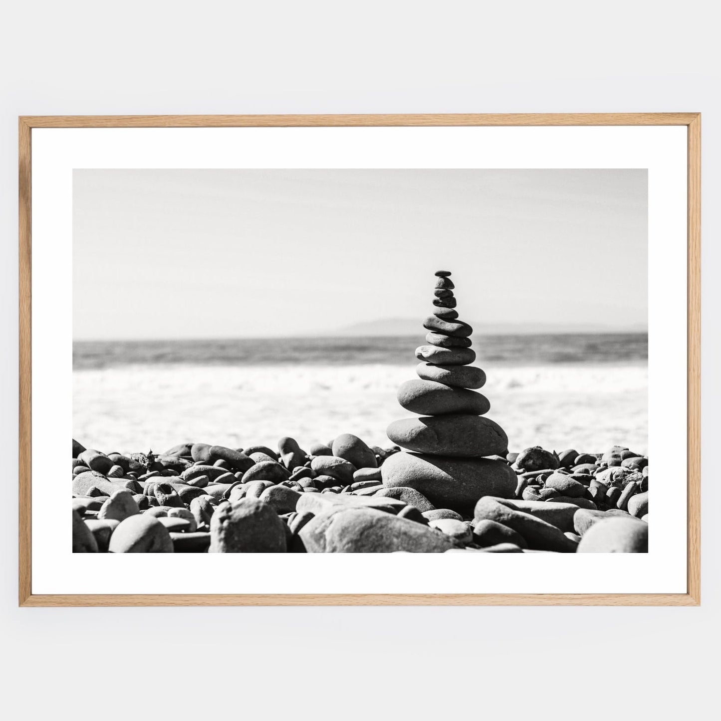 Poster with a photo of a tower made of pebbles