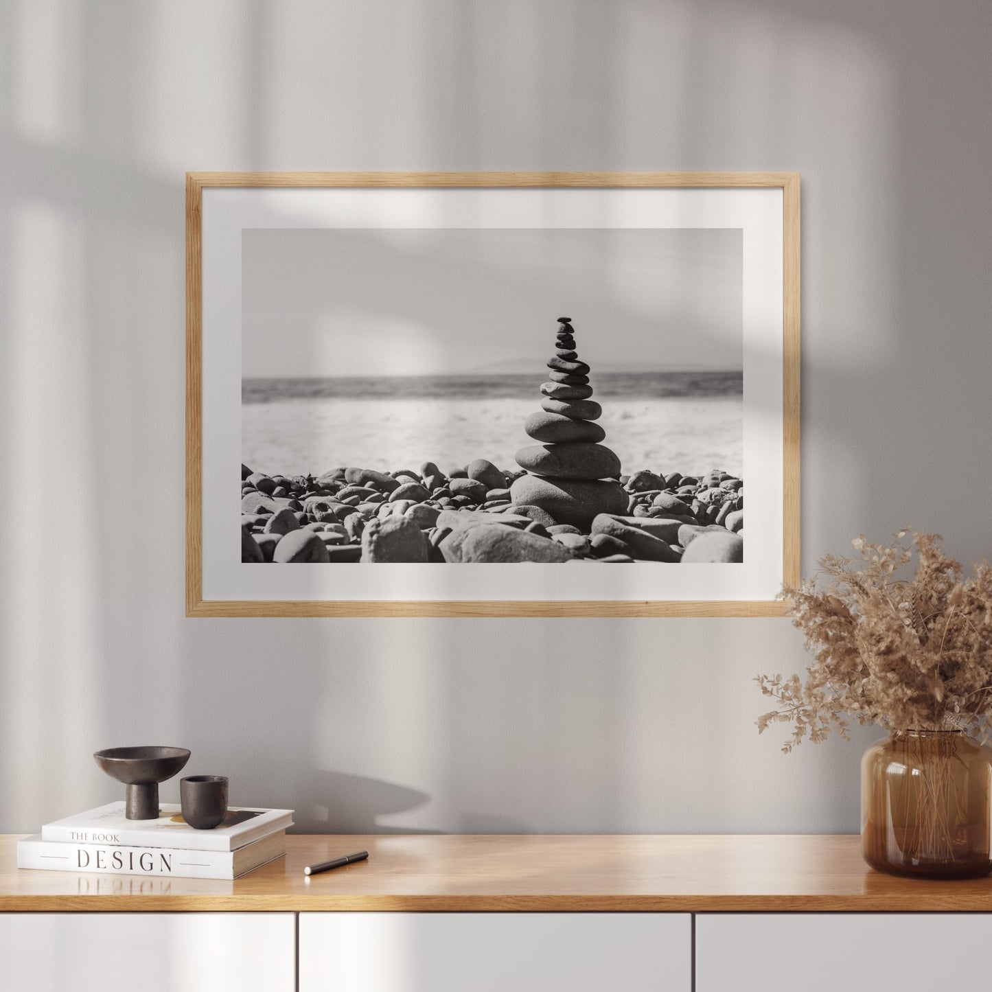 Poster with a photo of a tower made of pebbles