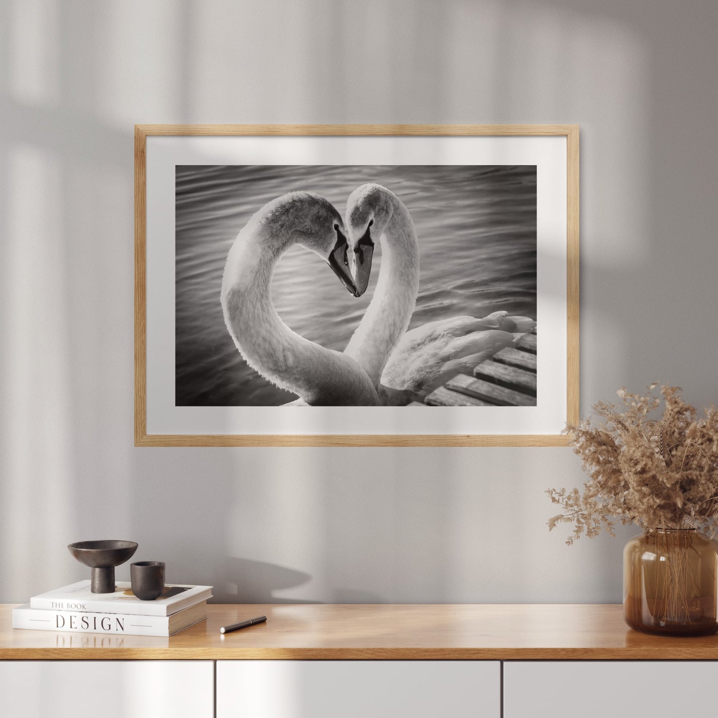 Poster with a black and white photo of two swans