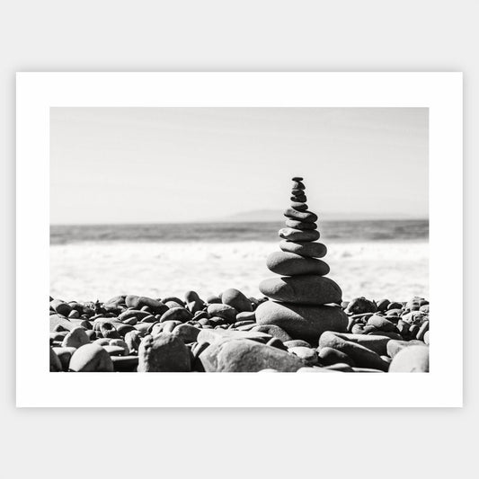 Poster with a photo of a tower made of pebbles